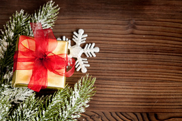gifts boxes with fir branches on wooden background top view