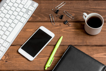 mans working place at wooden desktop with coffee