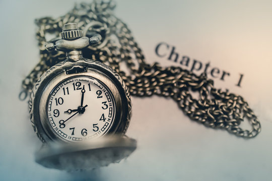 Pocket Watch on the open Book with Blank Space in Vintage Tone