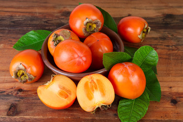 Persimmons kaki fruits on old wooden
