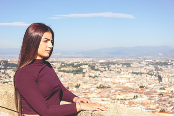 Close up of attractive young girl with long hair looking the beautiful panoramic view