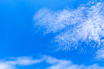 Blue sky background with white clouds. The vast blue sky and clouds sky on sunny day. White fluffy clouds in the blue sky.