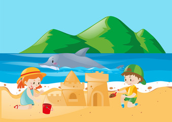 Two kids playing sandcastle on the beach
