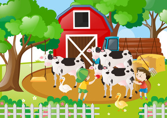 Farm scene with boys feeding cows