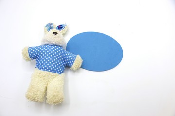 Rabbit soft toy in blue shirt on white background