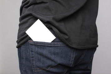 Close up man pulling a card on his back pocket, Blank card with copy space in a pocket of jeans.