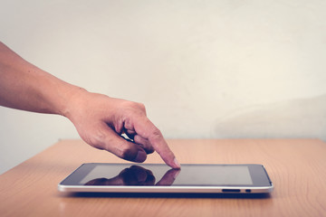 Man with modern mobile phone in hands touching on a blank screen
