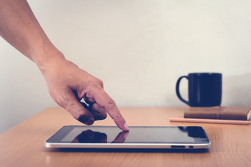 Fototapeta premium Man with modern mobile phone in hands touching on a blank screen