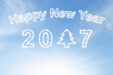 Happy new year 2017 and christmas tree cloud on blue sunshine sky
