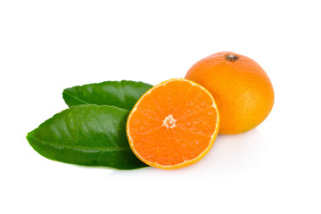 whole and cut ripe orange with leaf on white background