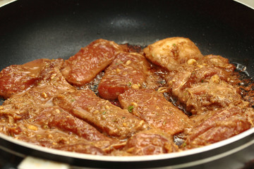 Cooking grilled pork with mixed herb served.  Selective focus.