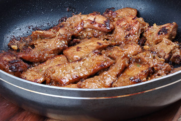 Ready grilled pork with mixed herb in pan  served.