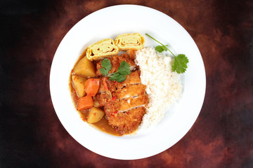 Rice with fried pork,omelet roll topped Japanese yellow curry .