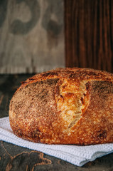 Freshly baked sourdough bread on wooden table.