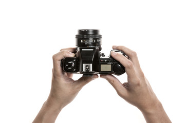 Two hands hold a vintage(old, classic) camera isolated white. 