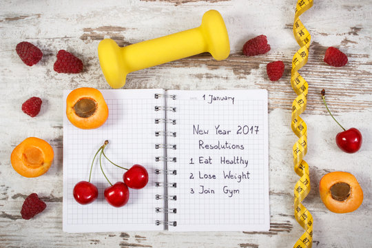 New year resolutions written in notebook on old board