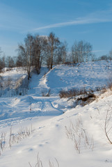 Beautiful winter landscape with snow-covered hills at sunset