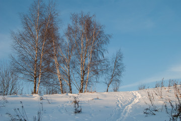 Obraz premium Beautiful winter landscape with snow-covered hills at sunset