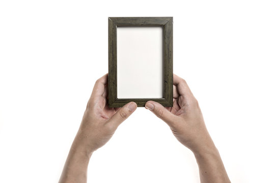 Two hands hold a photo(picture) wood frame isolated white.