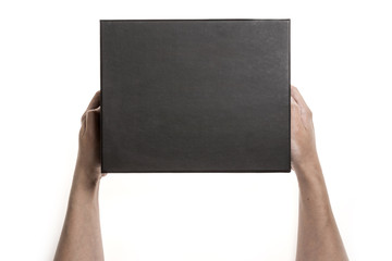 Two hands hold a empty(blank) black gift box isolated white