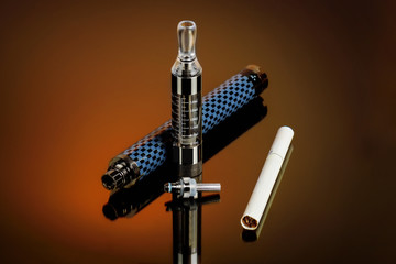 Vape, electronic cigarette exploded next to a conventional cigarette on a dark background with a gradient.