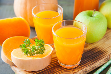 pumpkin apple juice in a glass, selective focus