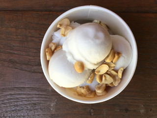 coconut Ice Cream homemade with nuts on wooden table, top view wood background