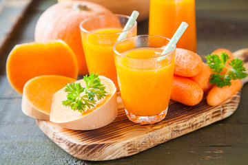 pumpkin carrot juice in a glass on a table, selective focus