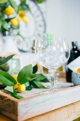 Close up tray with tangerines and glass