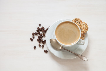 coffee in a cup and oat cookies on a table, selective focus, top view