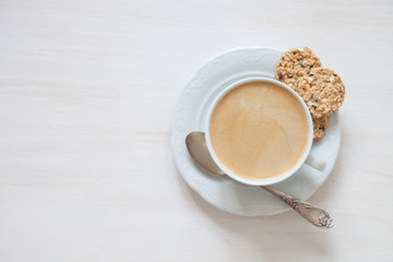 coffee in a cup and oat cookies on a table, selective focus, top view