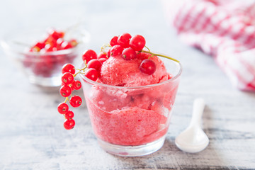 ice cream with berries in a glass on a table, selective focus