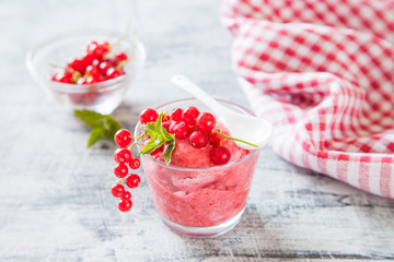 ice cream with berries in a glass on a table, selective focus