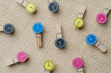 Wooden clothespins on burlap sack background.