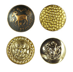 Beautiful textured metal buttons with ornaments and pictures of the silver and gold color close-up macro  isolated on white background.