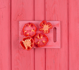 sliced red bell pepper on a red wooden table