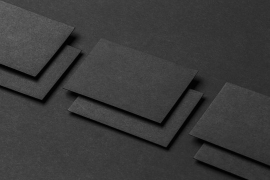 Mockup of business cards rows at black textured paper background
