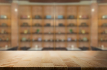 Selected focus empty brown wooden table and Coffee shop or restu