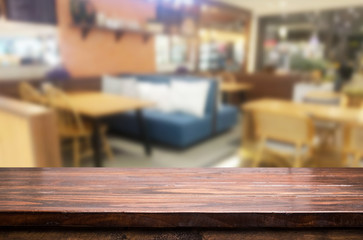 Selected focus empty brown wooden table and Coffee shop or restu