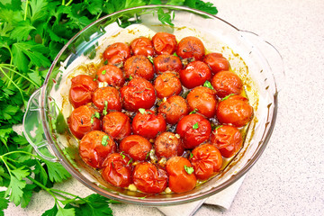Tomatoes baked in glass pan on table