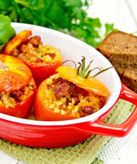 Tomatoes stuffed with bulgur in pan on napkin