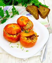 Tomatoes stuffed with bulgur in plate on board