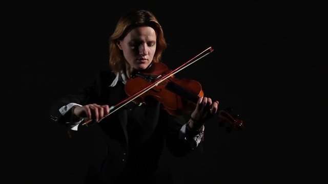 Woman On A Black Backgraund Playing On Violin In A Studio.