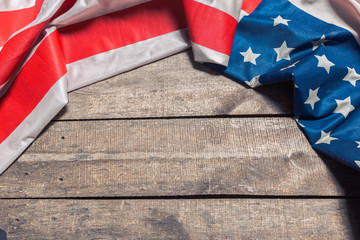 An American Flag Lying on an aged, weathered rustic wooden background