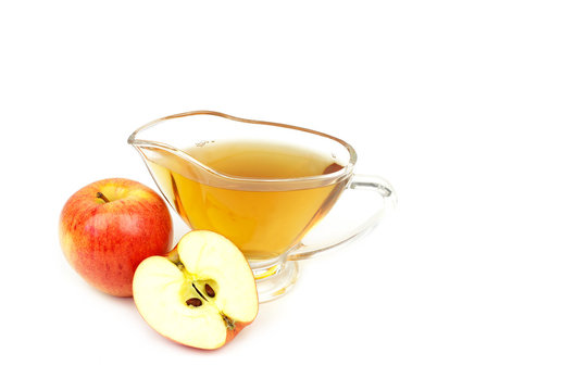 Apple vinegar and apples on white background