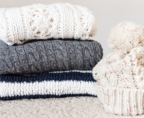 Fototapeta na wymiar Knitting winter clothes on light background.