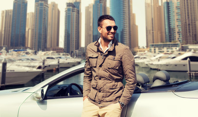 happy man near cabriolet car on city 