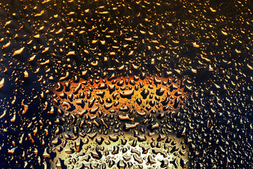 bright shiny bubbles of fluid on the glass
