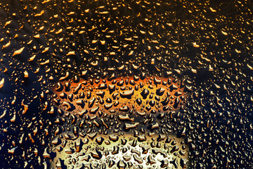 bright shiny bubbles of fluid on the glass