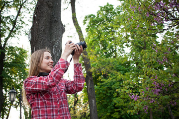 Smiling young woman with dslr camera 